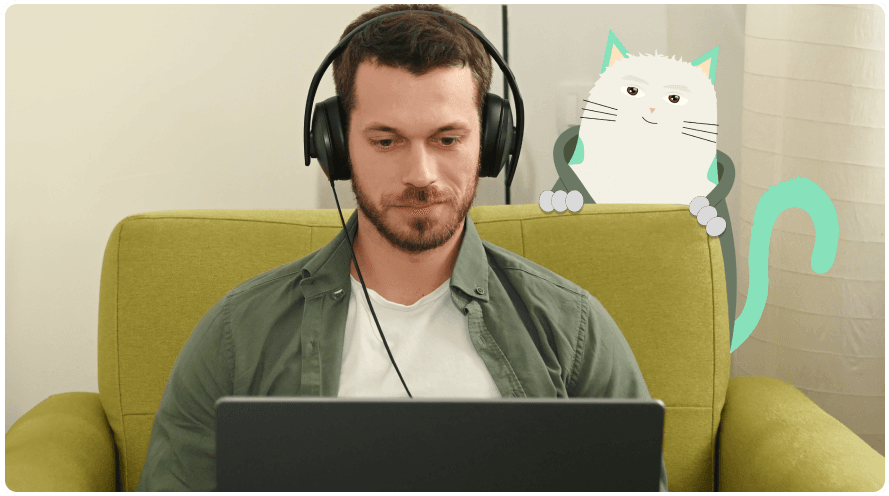 Male person programming and white cat behind his back.